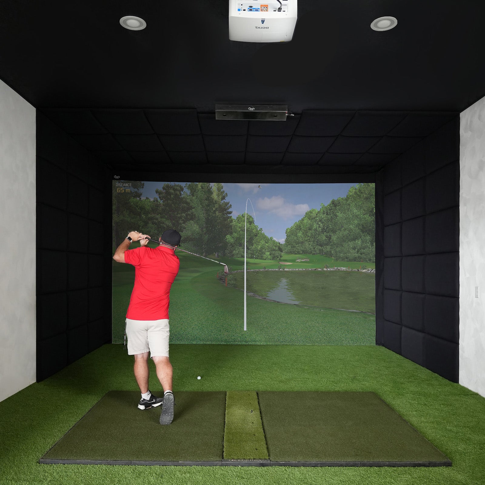 Golfer hitting an iron in a built-in golf room